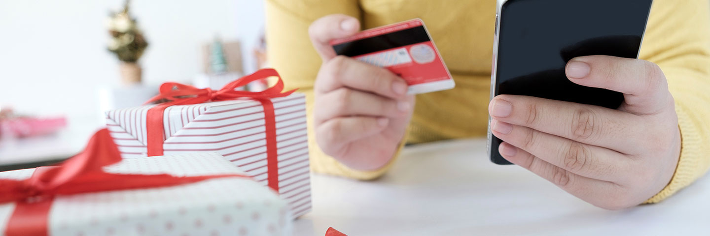 close up of shopping online on a mobile device with credit card in hand